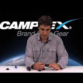 Man at Camplex Brand Fiber Gear desk presenting OPTIEYE Shutter Restraint for Neutrik OpticalCON Cable End Connectgor Inspection & Cleaning